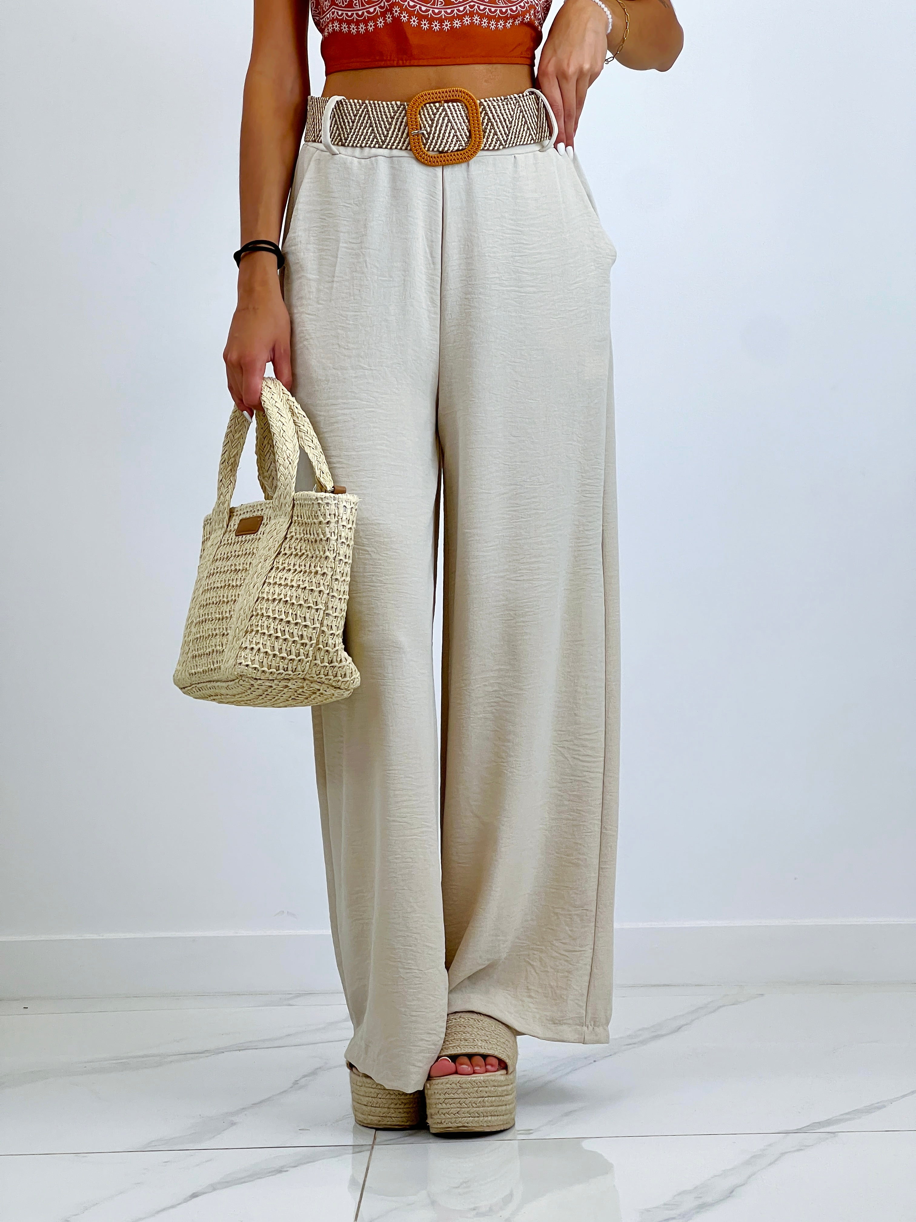 Flowing trousers with raffia belt